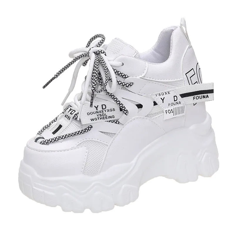 White and black women's low-top platform sports shoes with mesh upper and cross strap.