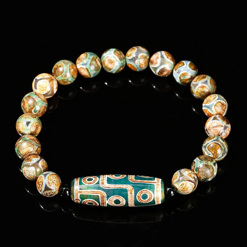 Handmade green dzi bead barrel shaped bracelet with 8mm natural agate beads on white background