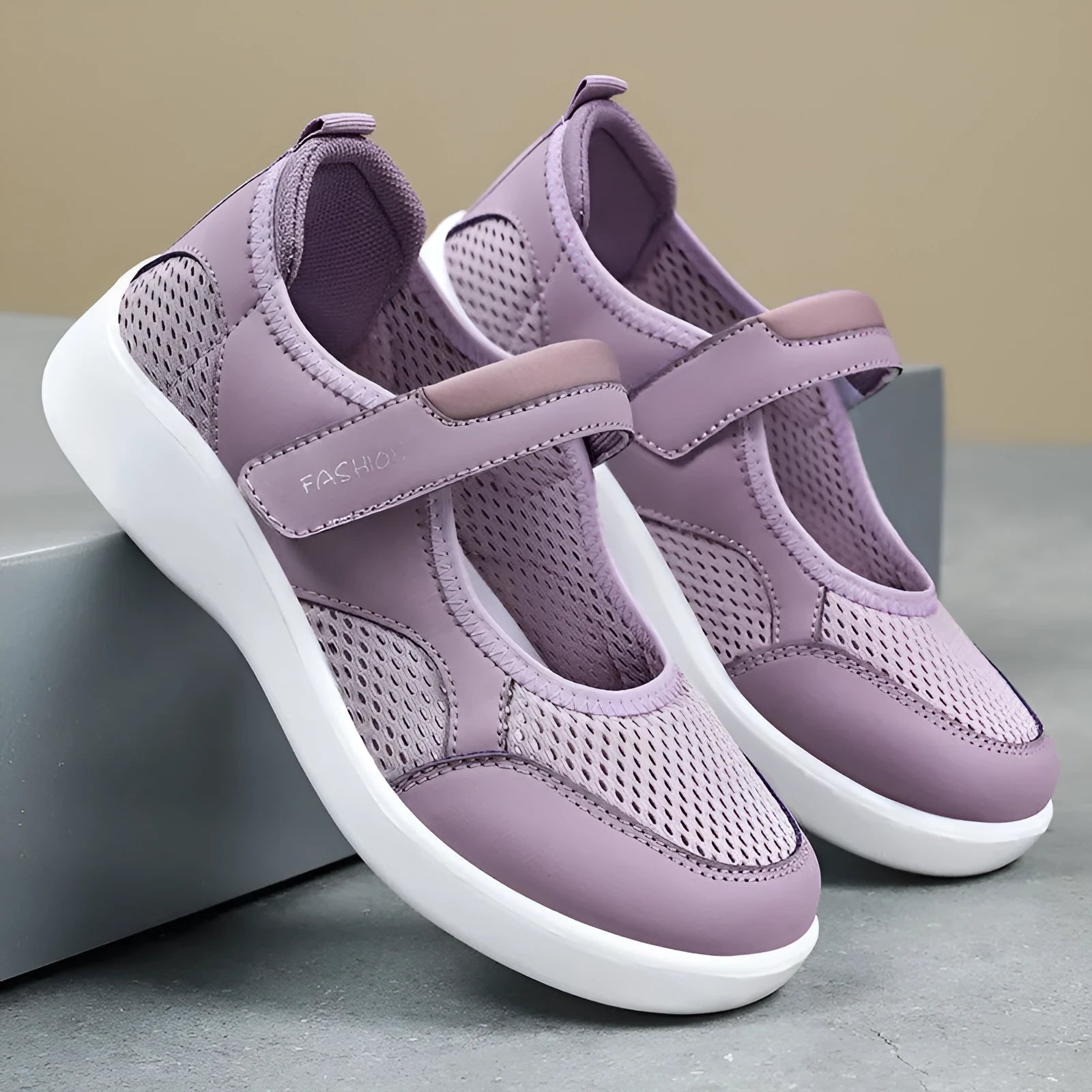 Women's grey low-top cloth shoes with mesh upper and Velcro strap on a flat sole.
