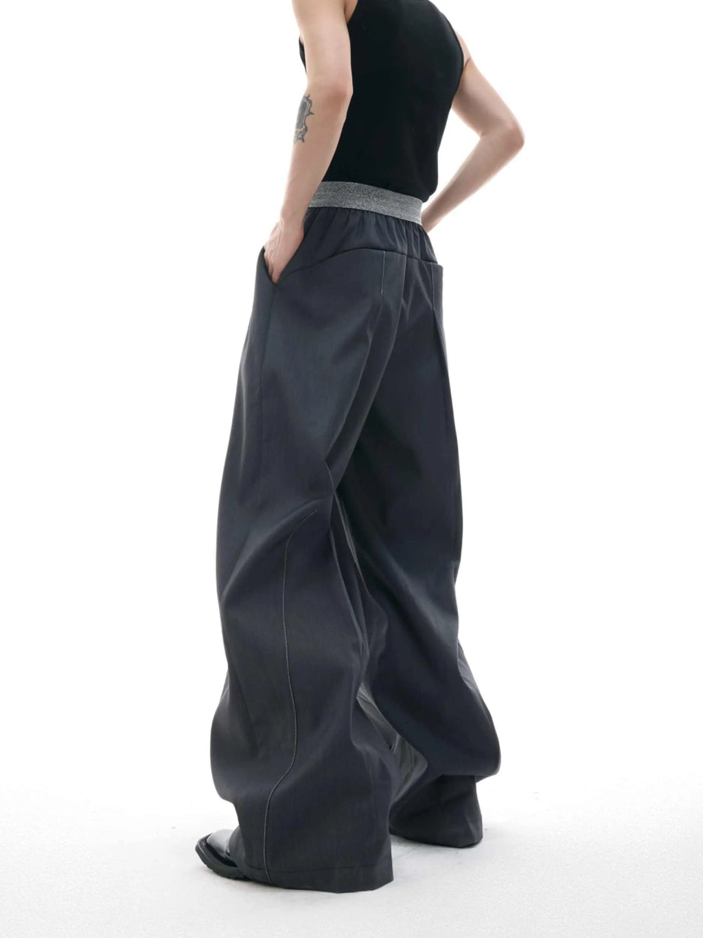 Drooping straight-leg high-waisted casual trousers with button detail in black and grey.