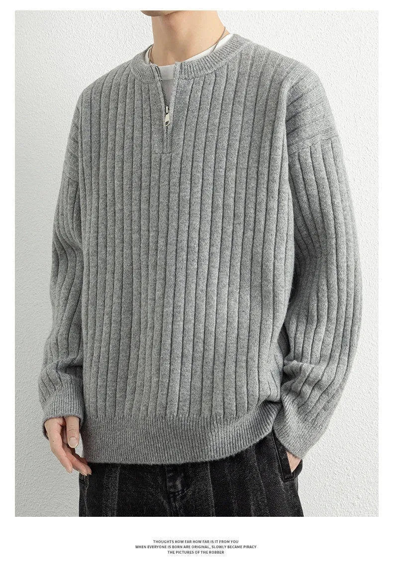 Men's loose grey half zip sweater with textured knit and long sleeves.