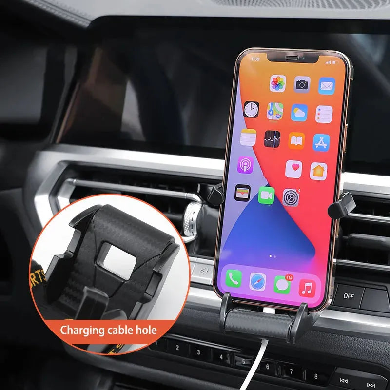Racing seat shape car phone holder clipped to a car air vent with a gold tape colour finish