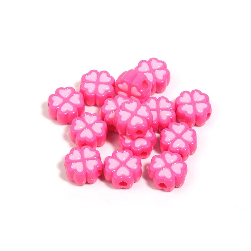 Acrylic four-leaf clover craft beads with love pattern in mixed colours showing frosted finish