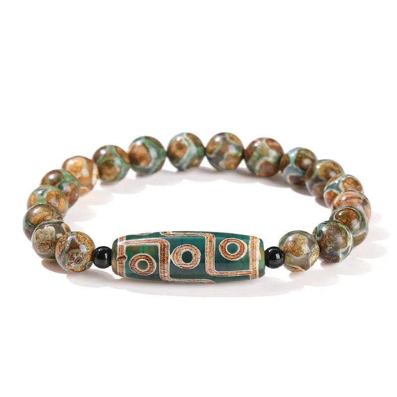 Handmade green dzi bead barrel shaped bracelet with 8mm natural agate beads on white background