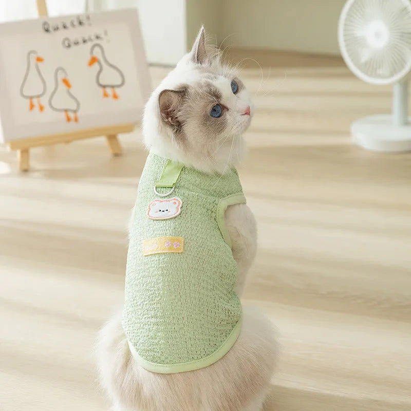 Green knitted cat clothing with a hollowed-out bear patch cartoon design.