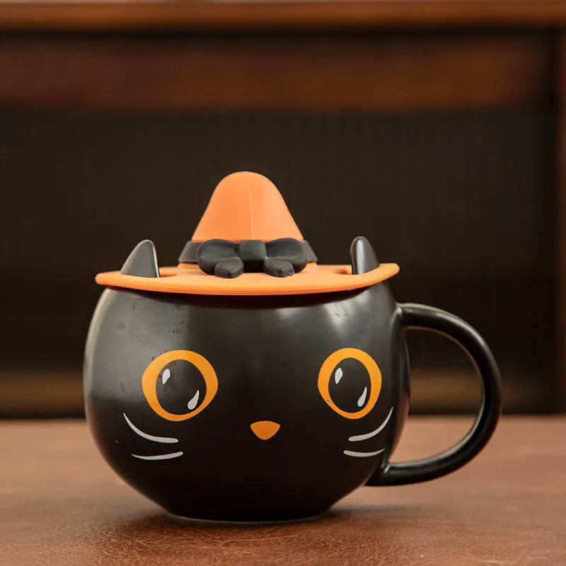 Black ceramic cat-shaped mug with pumpkin covered spoon on side