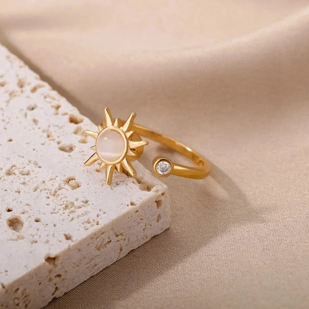 Simple gold adjustable spinner ring with rotating geometric component on a finger.