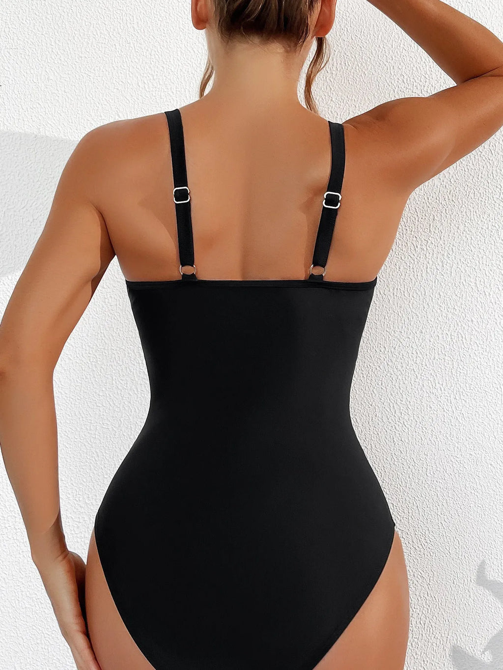 Black women's one-piece swimsuit with halter neck and mesh fabric panelling.