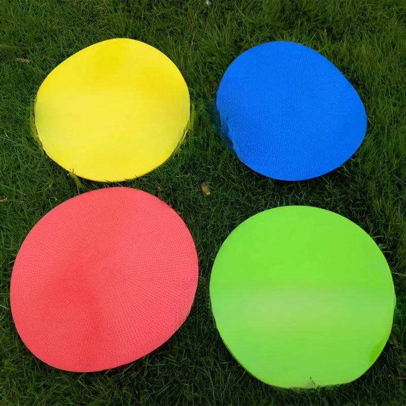 Yellow flexible TPE football training target disc, 23cm diameter, lying flat on grass.