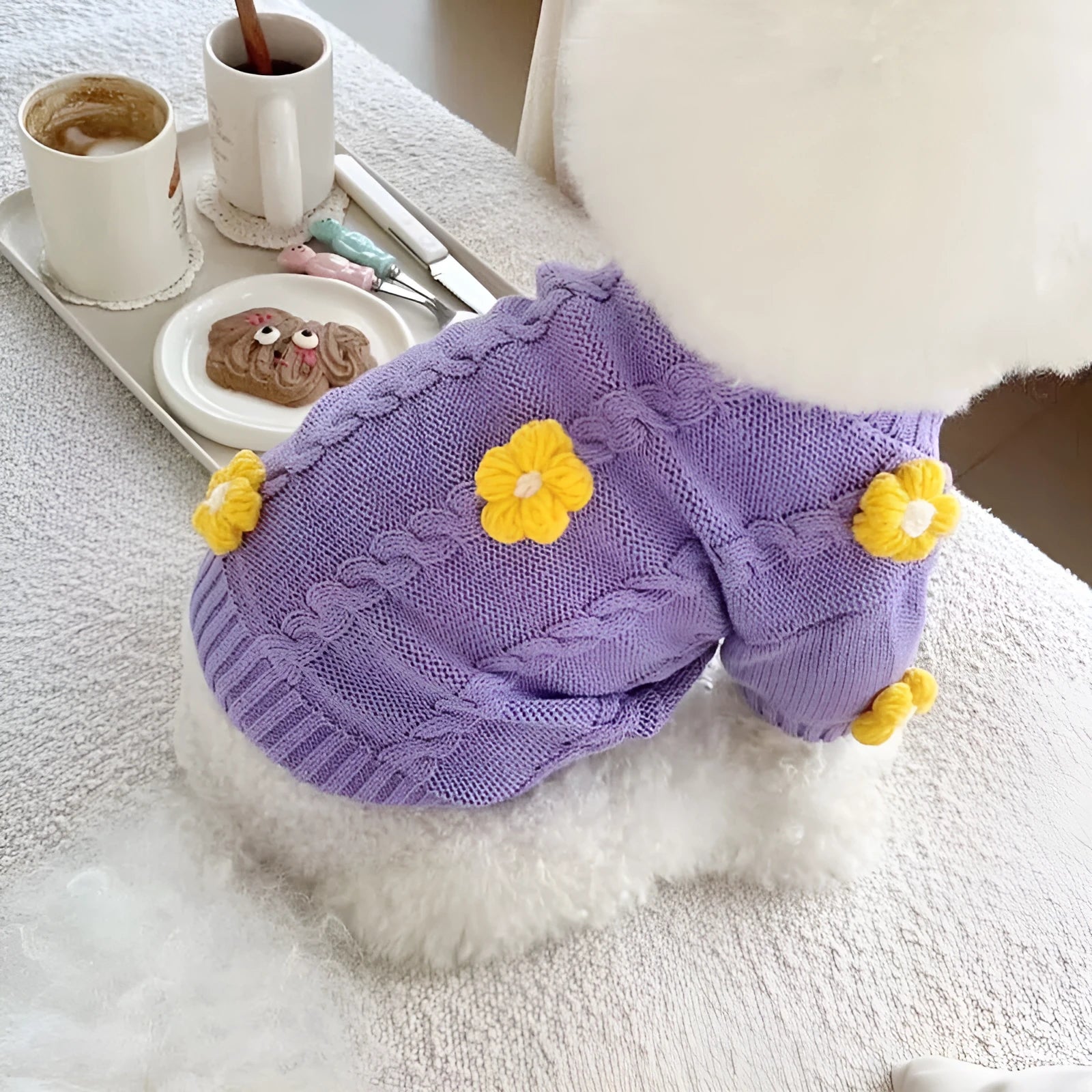 Purple knitted flower print dog clothes with size options from XS to XL on a plain background