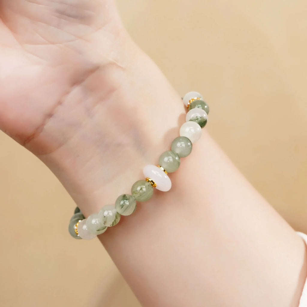 Emerald green Tian Shan Cui half bracelet with floating flower girl design and round motif on light background