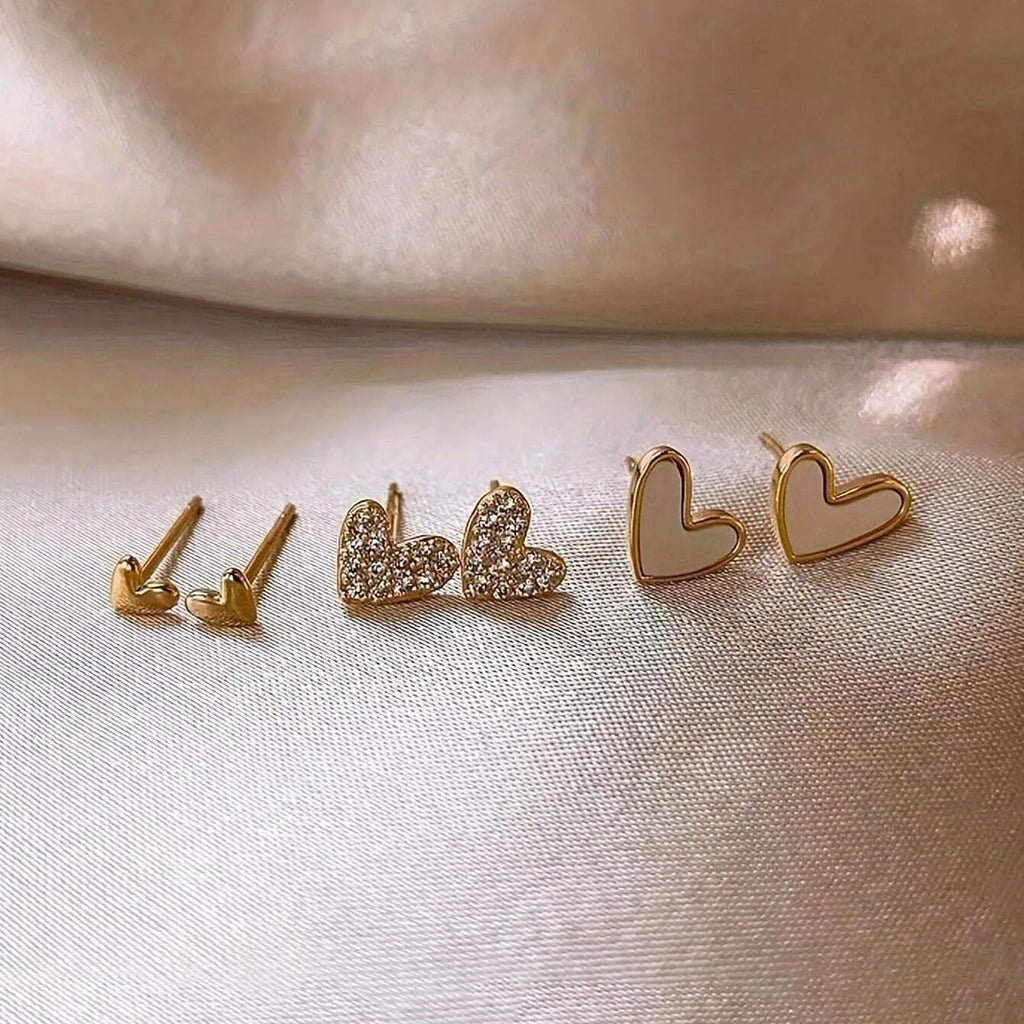 Three pairs of women's heart-shaped alloy earrings in coordinated set with electroplated finish