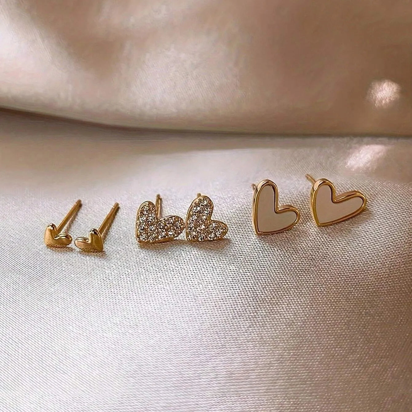 Three pairs of women's heart-shaped alloy earrings in coordinated set with electroplated finish