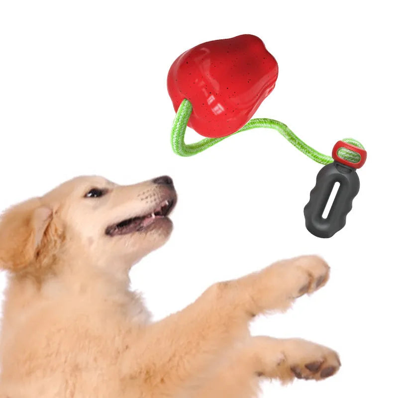 Green and red plastic apple-shaped dog toy with dropping ball for food dispensing