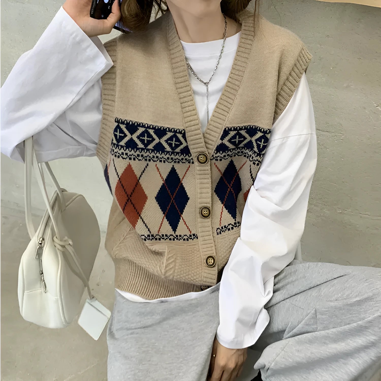 Loose diamond plaid sleeveless cardigan top in khaki colour showing front view