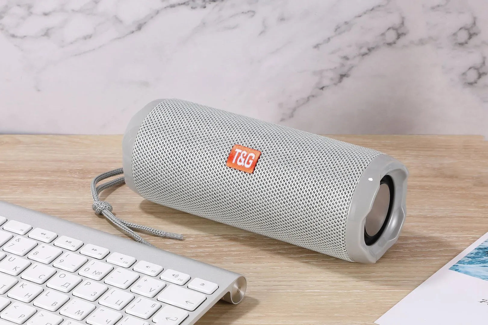 Fabric-covered portable Bluetooth speaker with integrated card holder in multiple colour options