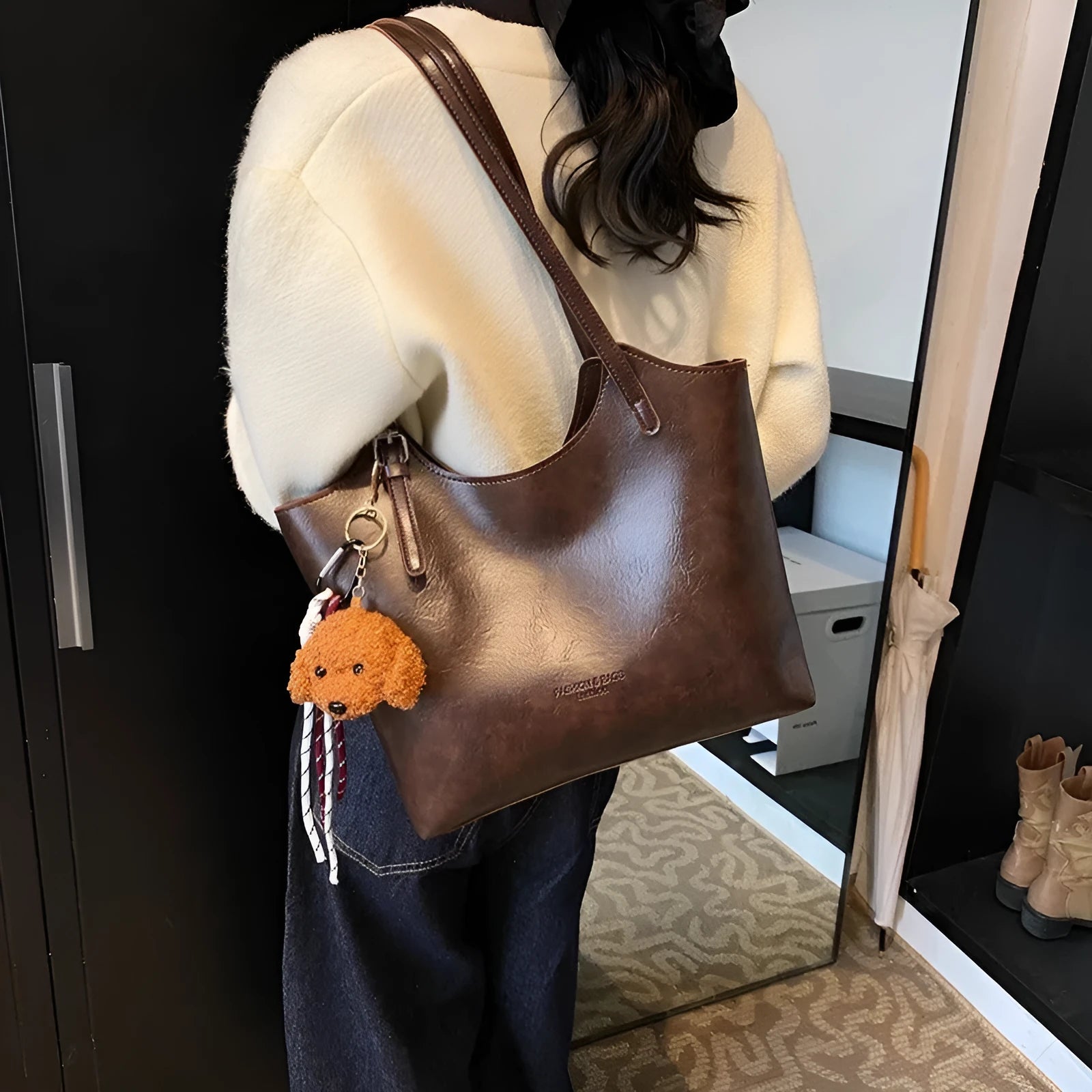 Women's PU commuter shoulder bag in black with stitching details and optional ribbon pendant, horizontal square shape