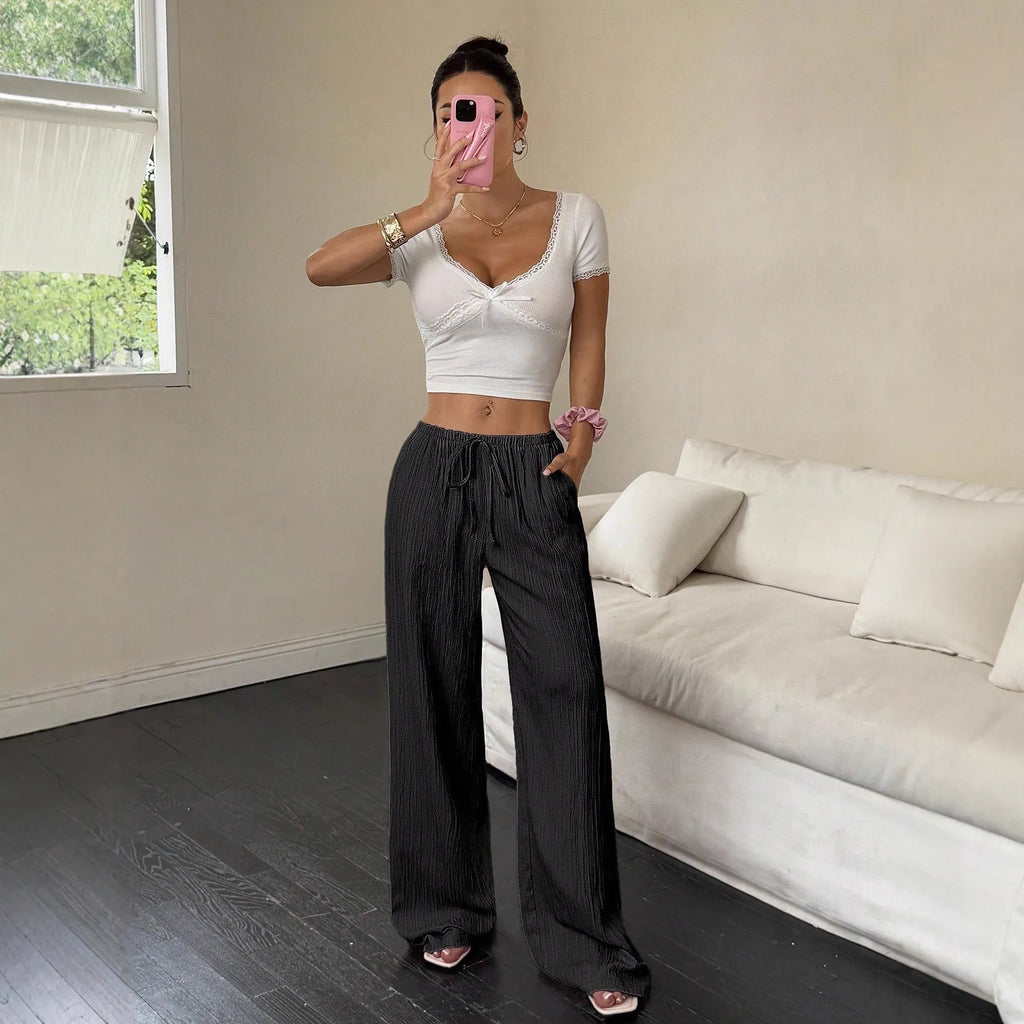 Women's black wide-leg trousers with lace-up waist detail on mid waist