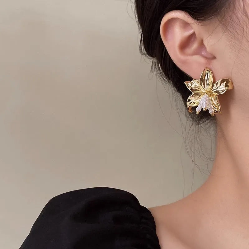 Gold H1795 metal flower earrings with pearl design and Seiko treatment