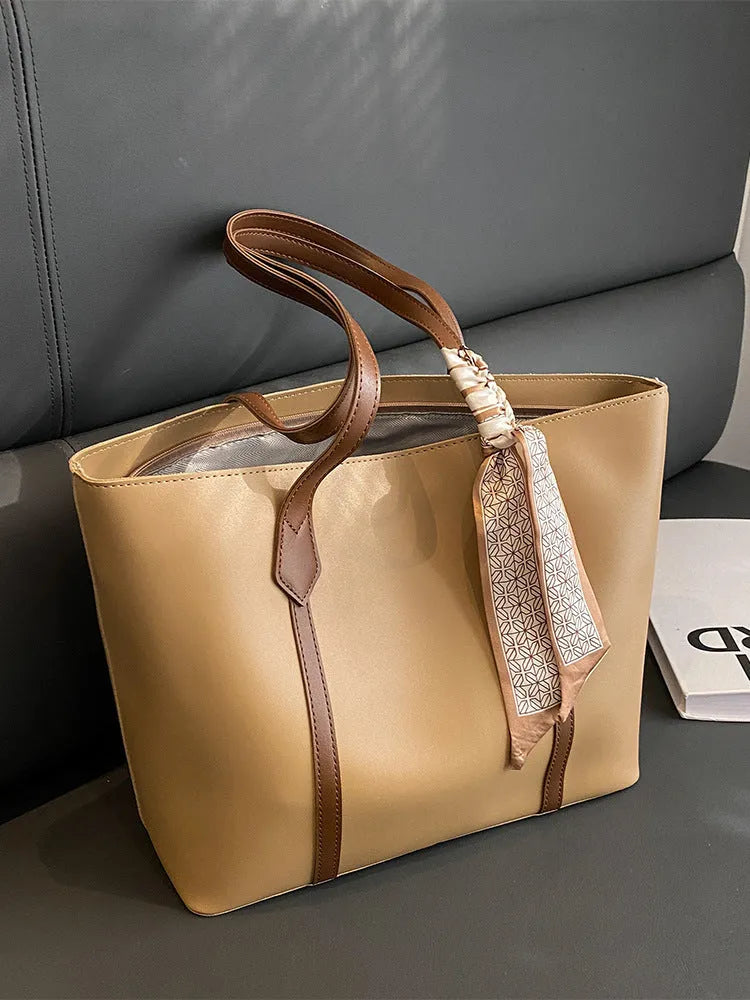 Women's large capacity soft tote bag in multiple colour options showing bucket design and crossbody strap
