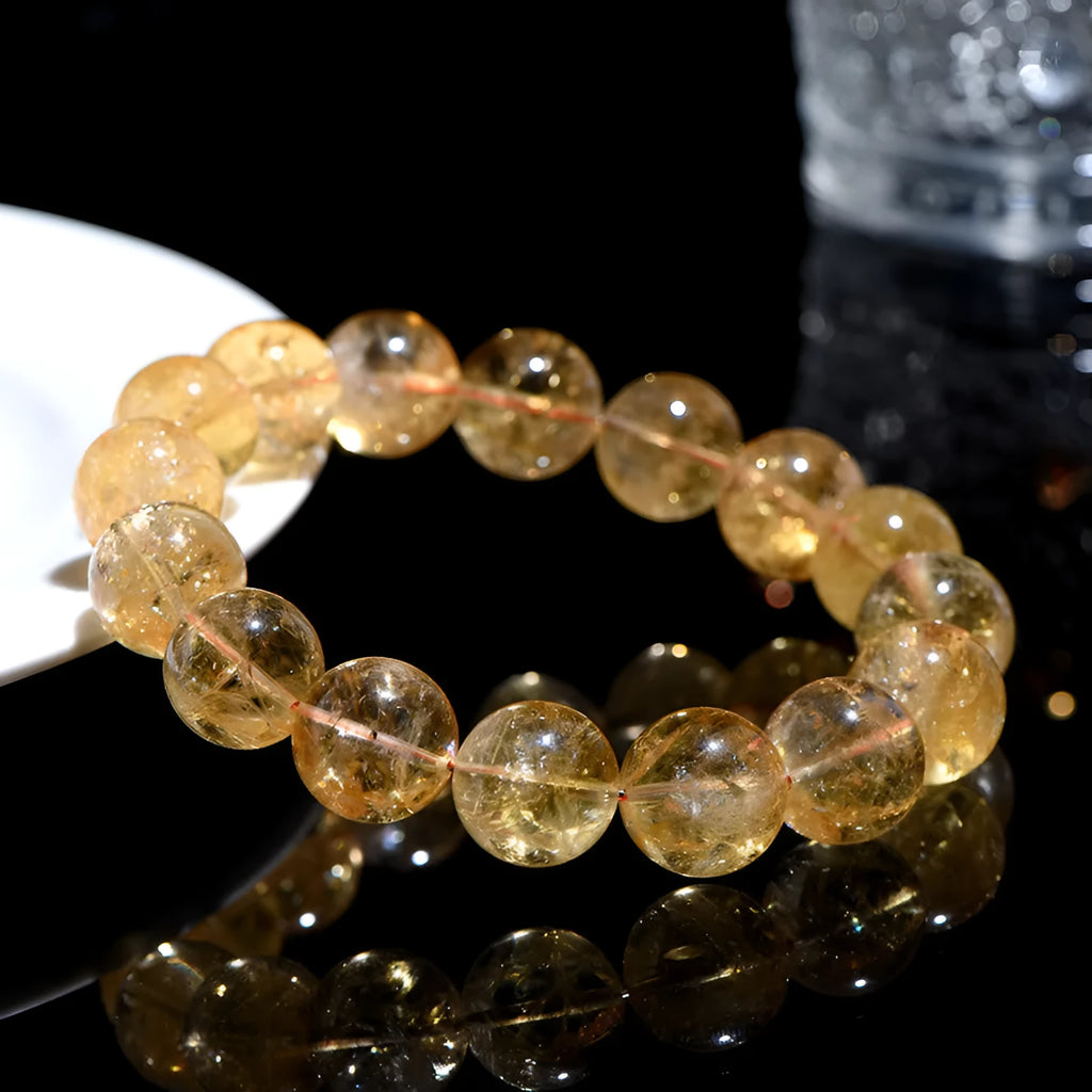 Natural yellow citrine bead bracelet showing geometric Asestelle cutting in both single and three-circle configurations
