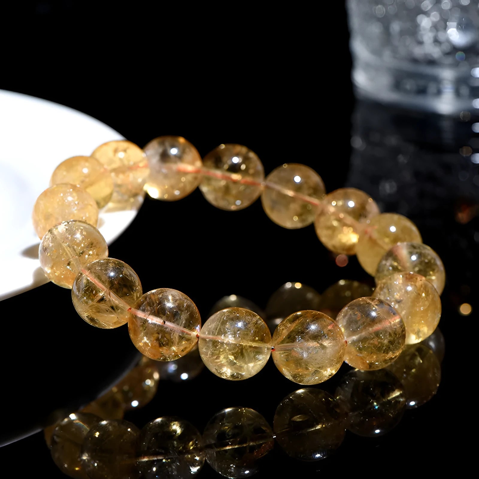Natural yellow citrine bead bracelet showing geometric Asestelle cutting in both single and three-circle configurations