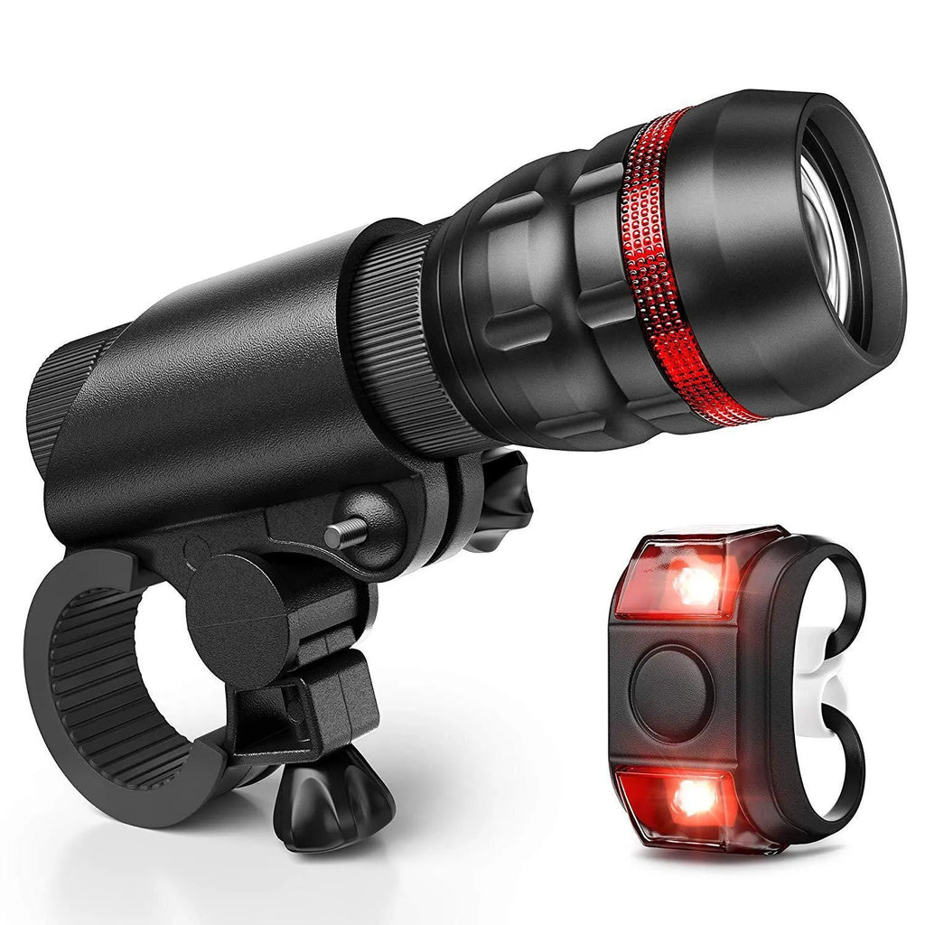 Bicycle front headlight and rear taillight set with mounting bracket on a black background