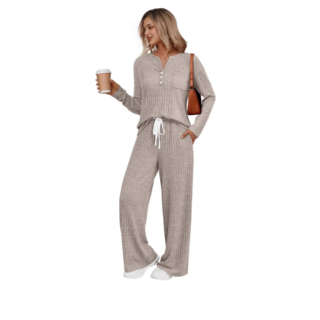 Women's knitted long coat and trouser set in a stripe pattern with V-neck and lace-up detail.