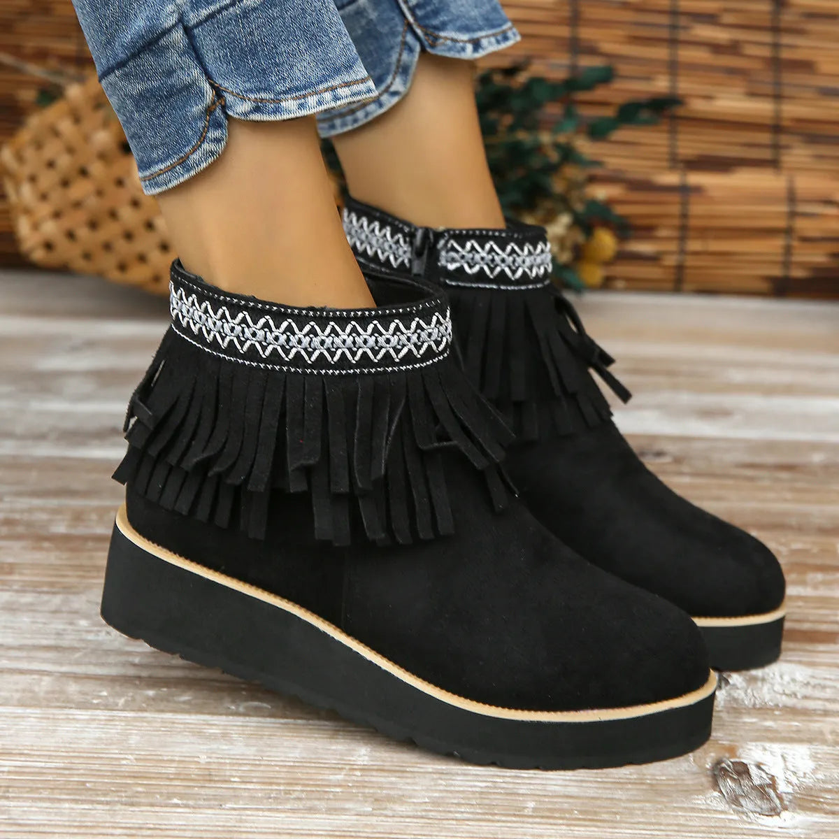 Women's suede wedge booties with side zipper, thick rubber sole, and tassel detail in black colour