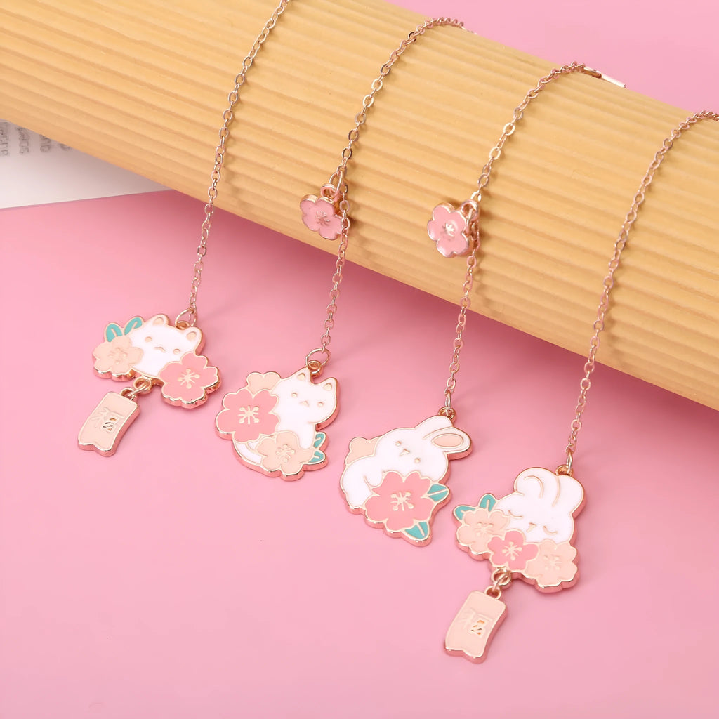 Creative cartoon metal pendant bookmark with cute cherry cat design in sakura style on white background