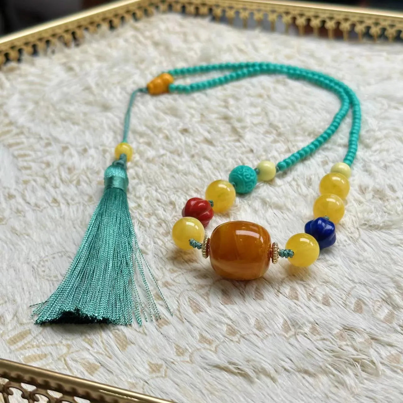 Turquoise stone lucky pendant necklace with hand-woven mesh flower design on a ball bead chain.
