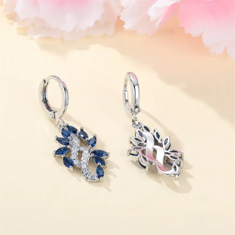 Women's simple minority all-match earrings in platinum sapphire blue alloy on display