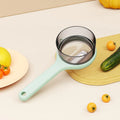 Kitchen multi-functional peeler with bucket storage in light green and orange colours, food-grade plastic construction