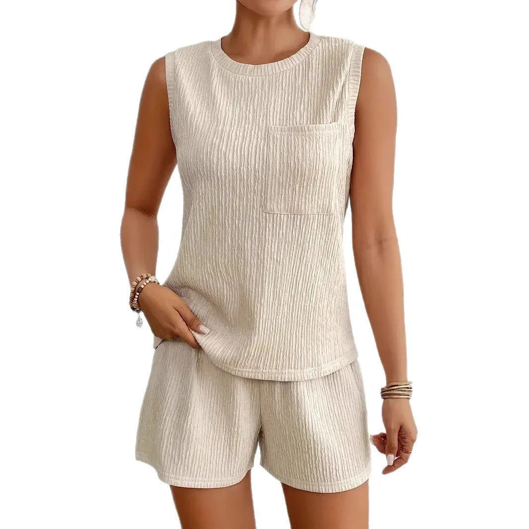 Apricot or orange sleeveless round neck vest and matching shorts set laid flat