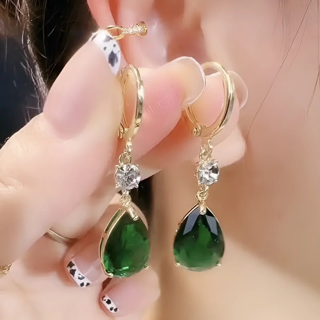 Green geometric teardrop alloy earrings with post findings on plain background