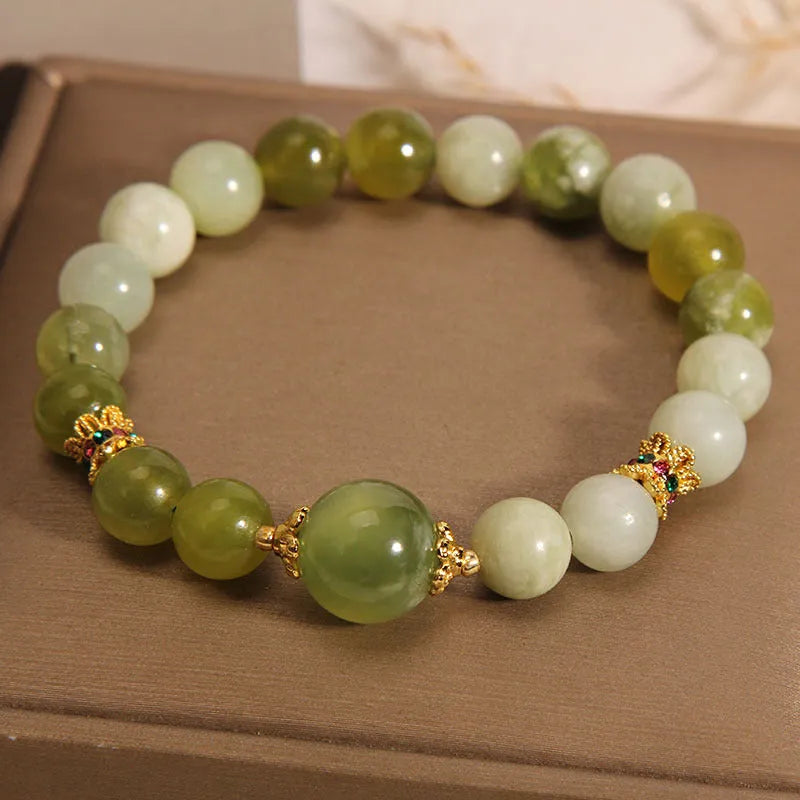 Women's bracelet in Xiuyan jade green with original design on display