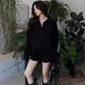Women's creamy-white cable knit sweater and shorts set with geometric pattern and elastic waistband