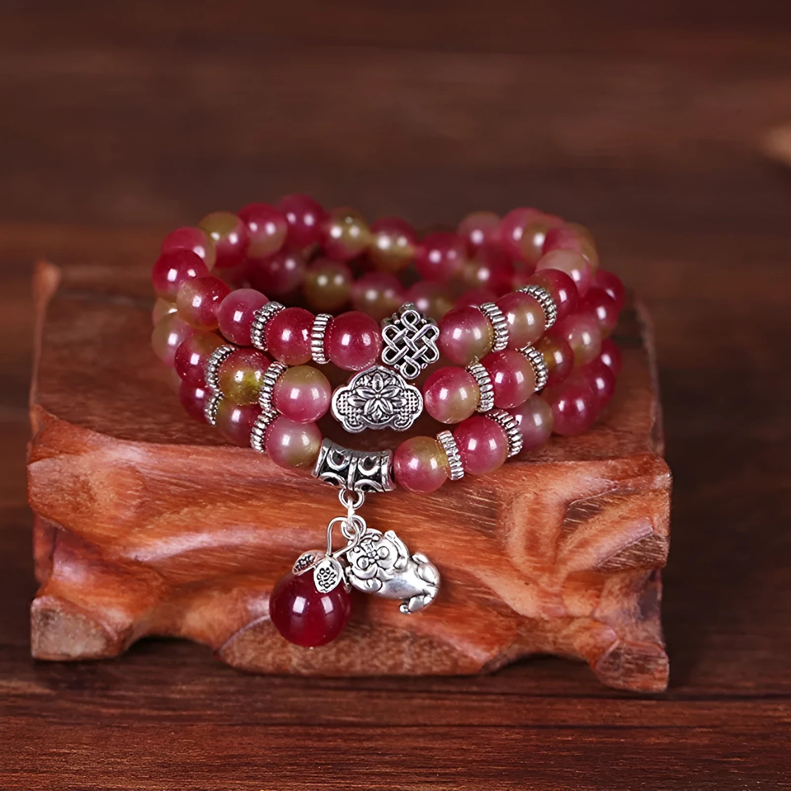 Handmade geometric bracelet made from natural watermelon crystal beads with a traditional Chinese knot clasp.