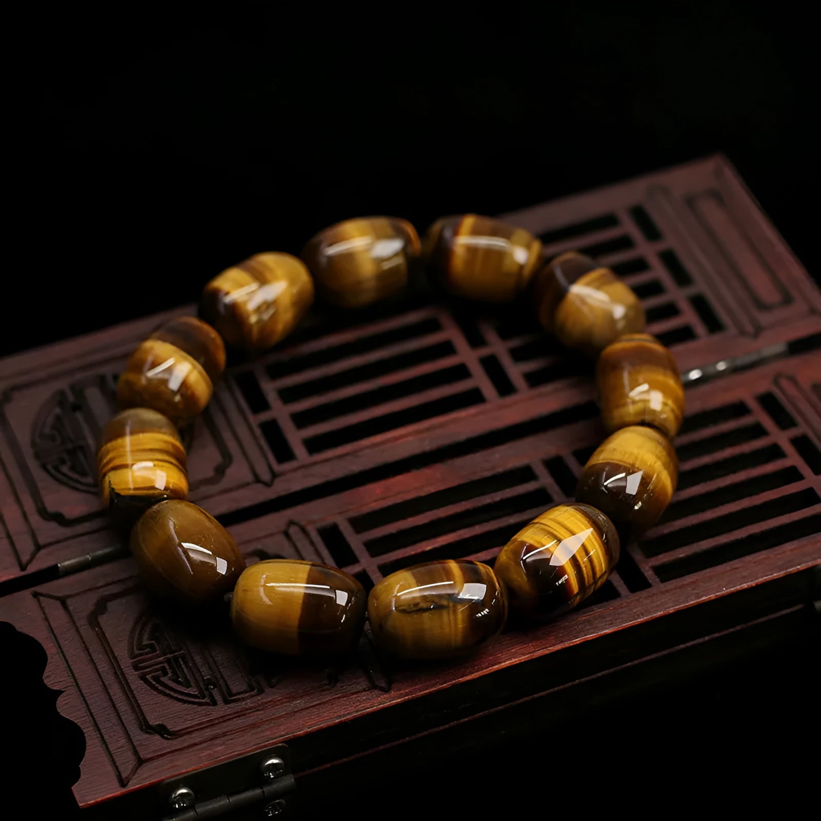 Natural yellow tigereye bracelet with sunny cat eye effect, ball beads in 11x16mm size on light background