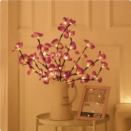 Pink Phalaenopsis branch shaped decorative LED light with 20 warm white lights, powered by batteries.