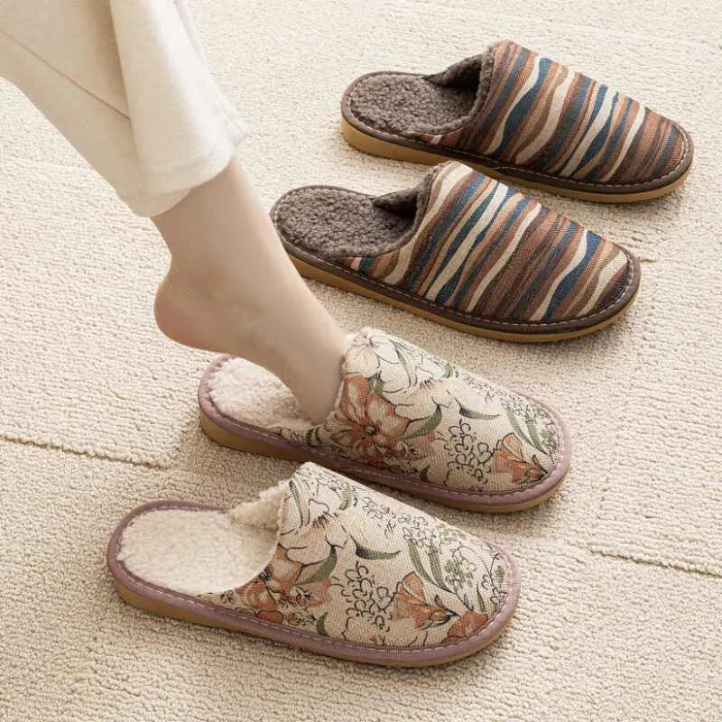 Warm winter linen surface household cotton slippers with PVC sole in gold coffee/cotton colour on a wooden floor