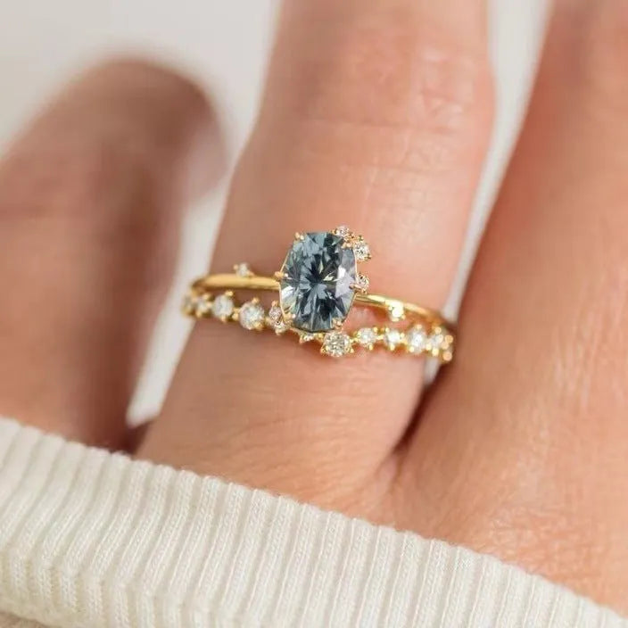 Gold-plated flower-shaped ring with green zircon stones on a model finger
