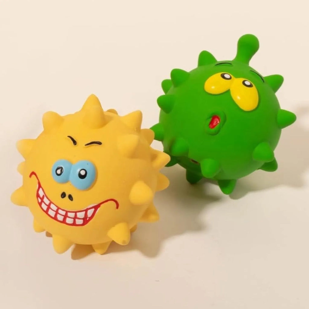 Set of four coloured natural latex squeaky dog balls with cute faces and textured surfaces