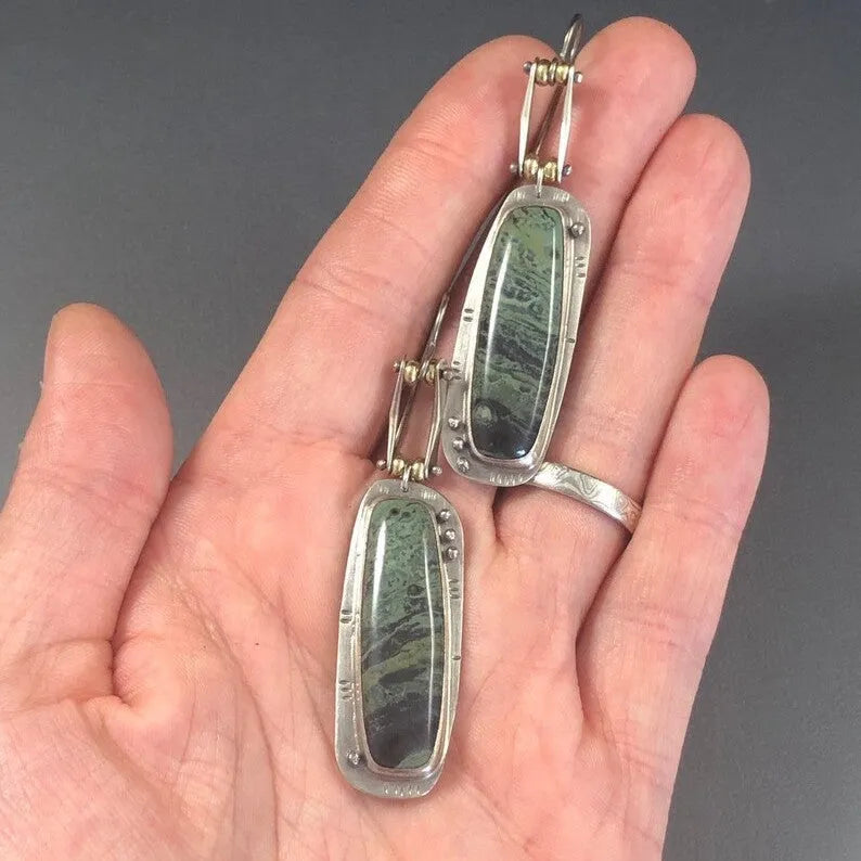 Simple geometric alloy earrings with a two-colour marble pattern and stainless steel posts.