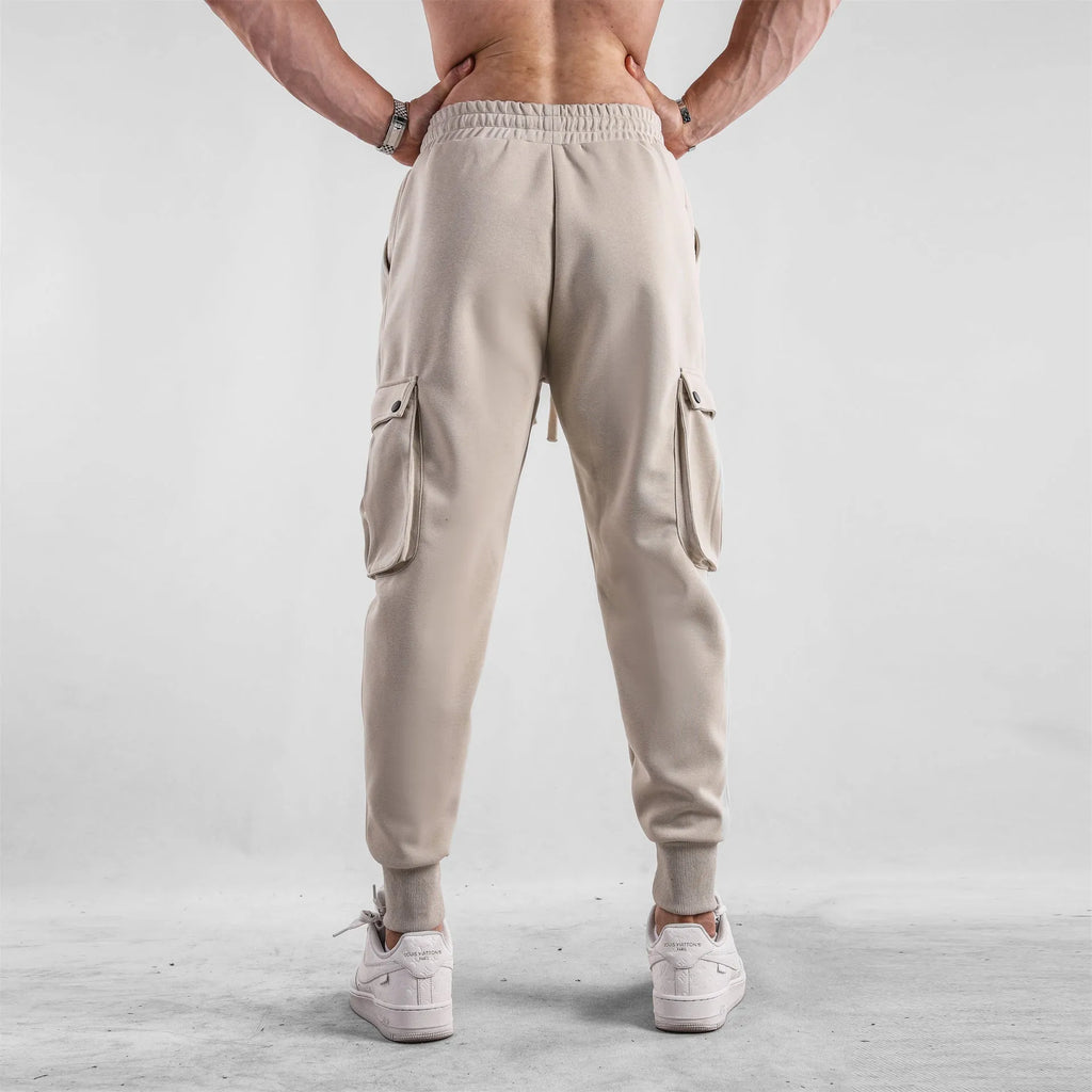Men's loose cotton trousers with multiple pockets and adjustable ankle ties in solid colour options