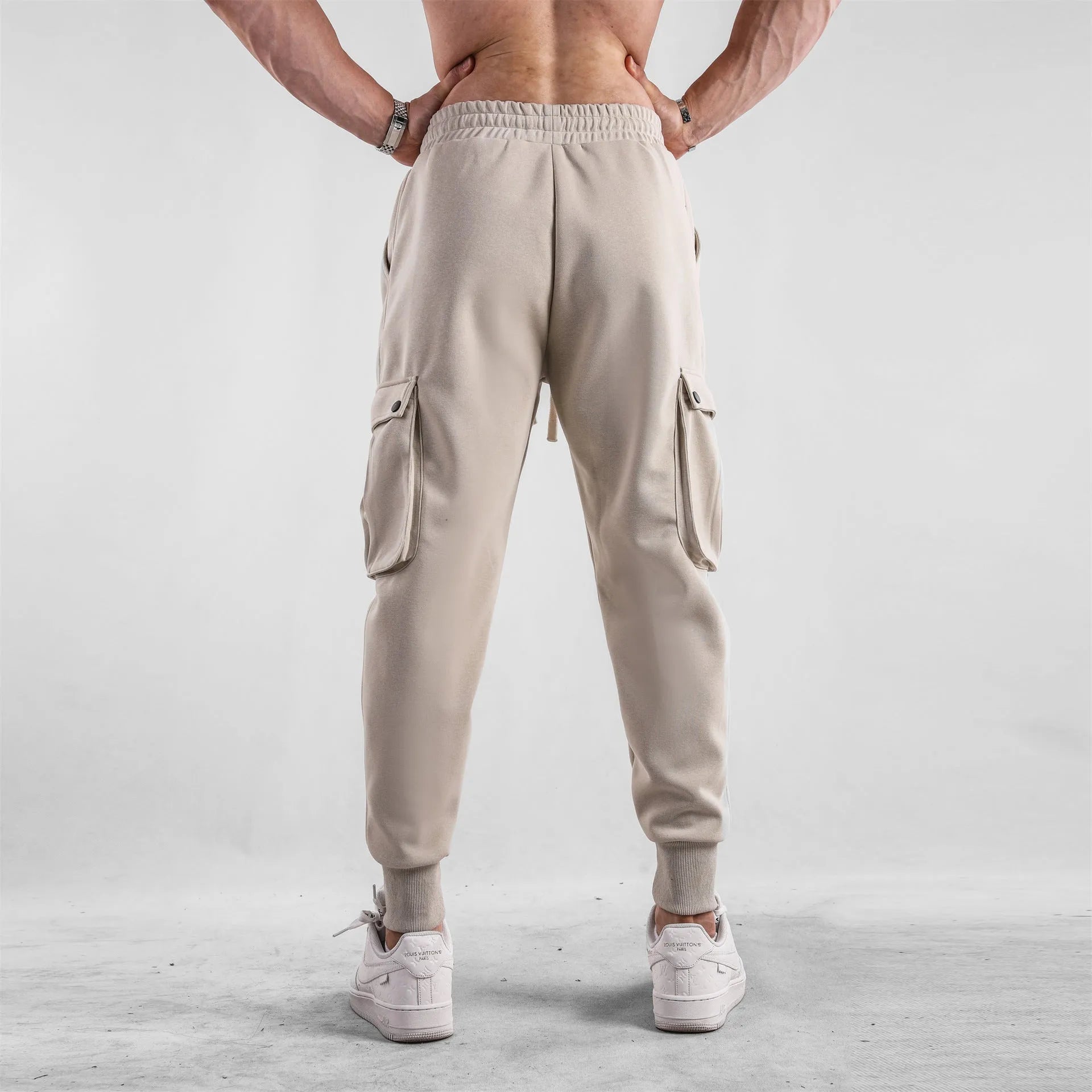 Men's loose cotton trousers with multiple pockets and adjustable ankle ties in solid colour options