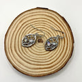 Silver alloy leaf-shaped earrings with embedded colourful moonstone gemstones and diamond-cut treatment