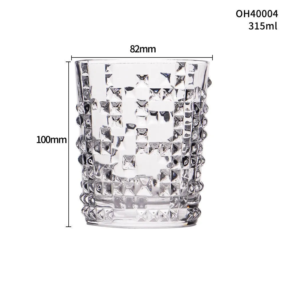 Clear thick-bottomed whiskey glass with 301-400ml capacity on a table.