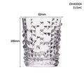 Clear thick-bottomed whiskey glass with 301-400ml capacity on a table.