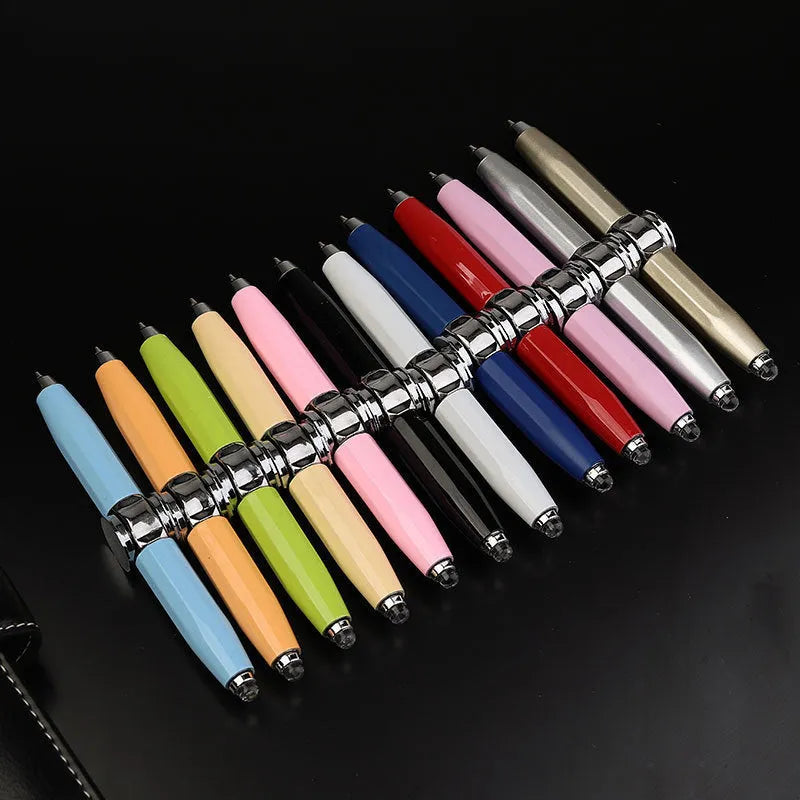 A silver metal gyro ballpoint pen with a built-in spinner section, shown with multi-coloured ink refills.